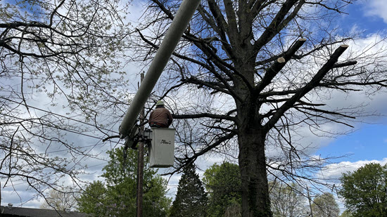 Bucket truck working carefully near power lines